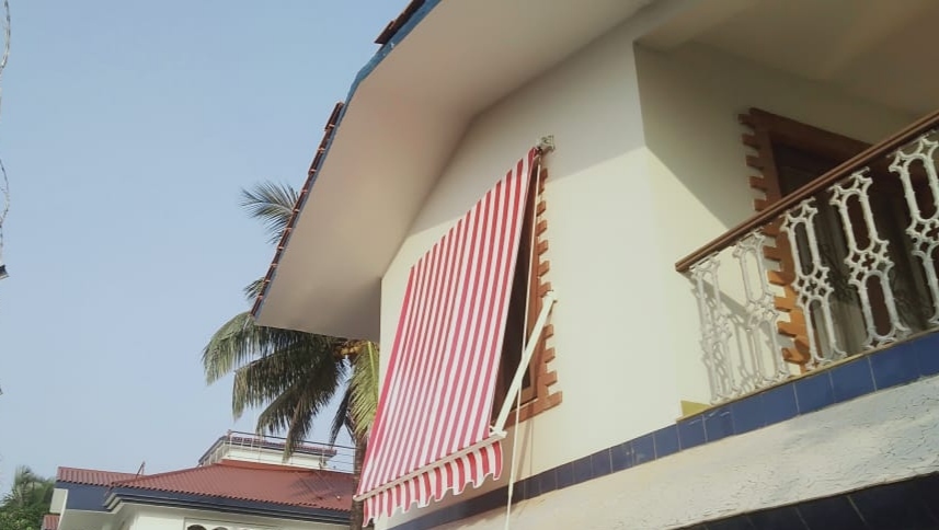 Drop arm awning
